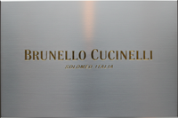 Brunello Cucinelli logo gold letters, silver background